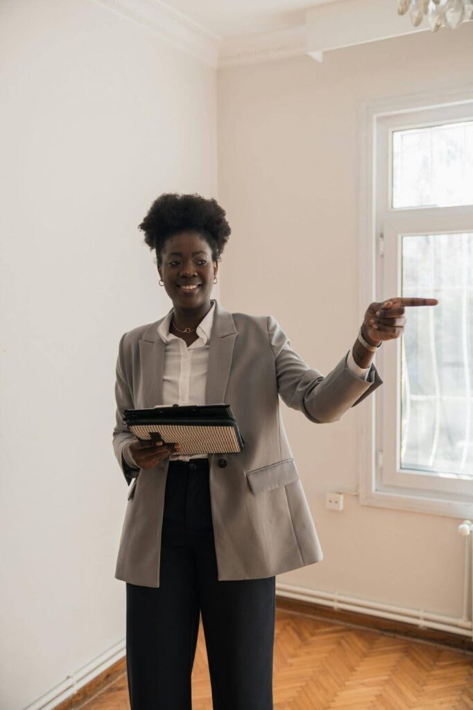 The Importance of Seeking Professional Advice Person in a suit holding a tablet, pointing in a bright room.