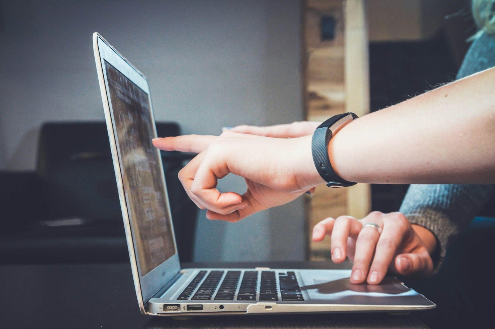 two people working together using a laptop