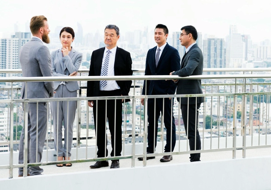 A group of people involved in serious discussion outside office.
