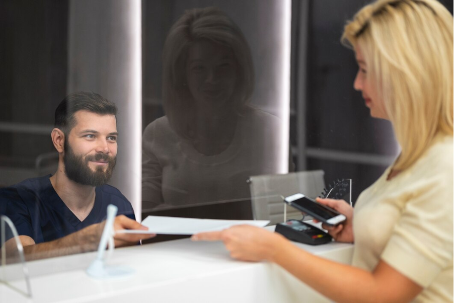A Bank employee interacting with a customer over the counter