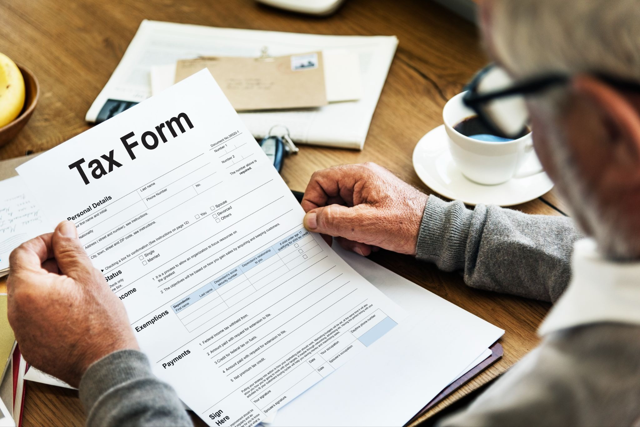 An old man looking at a Tax Form